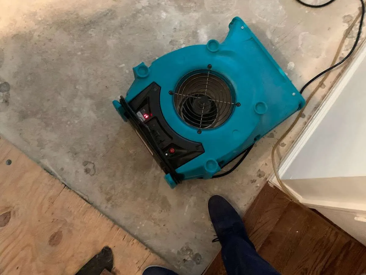 Air mover drying subfloor during Commercial Water Damage Restoration in Navarre